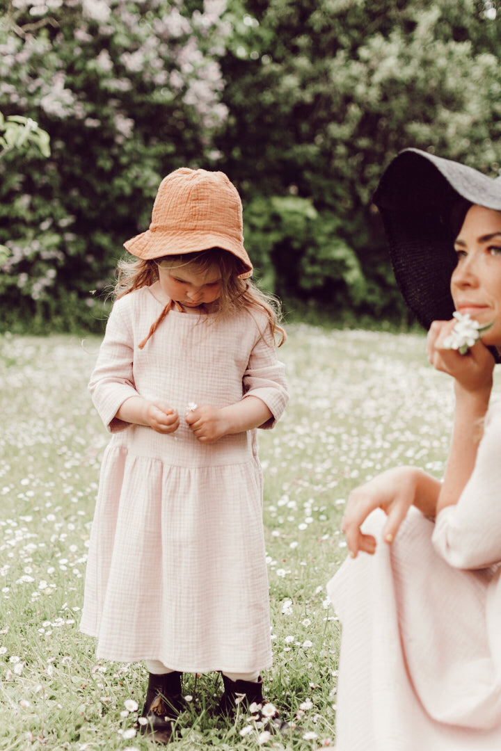 Soft pink girls muslin dress with 3/4 sleeves made with organic cotton. This sustainable girls dress is good for eczema prone skin. Mini Me fashion available.