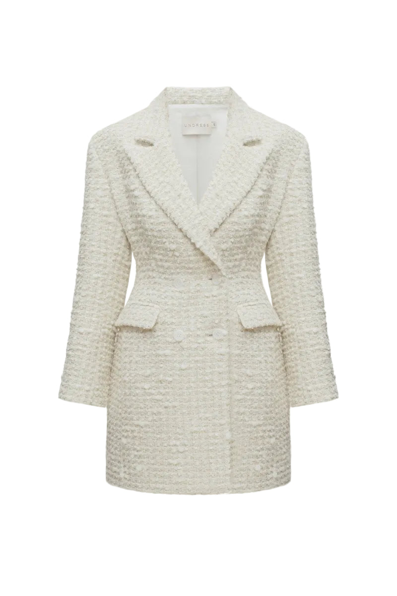 Undress Petra creamy tweed mini blazer dress shown on a model, featuring a tailored fit with classic lapels and long sleeves.