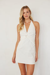 white-image | Woman wearing a white halter neck dress against a plain background