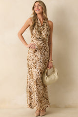 Maxi dress in satin with halter cowl neckline, fitted waist, and flowing bias-cut skirt layered over a tan mini-length lining, shown from a slightly angled front view.