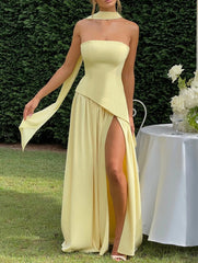 Buttercream yellow wedding guest dress with structured strapless bodice and gathered chiffon skirt, studio image.