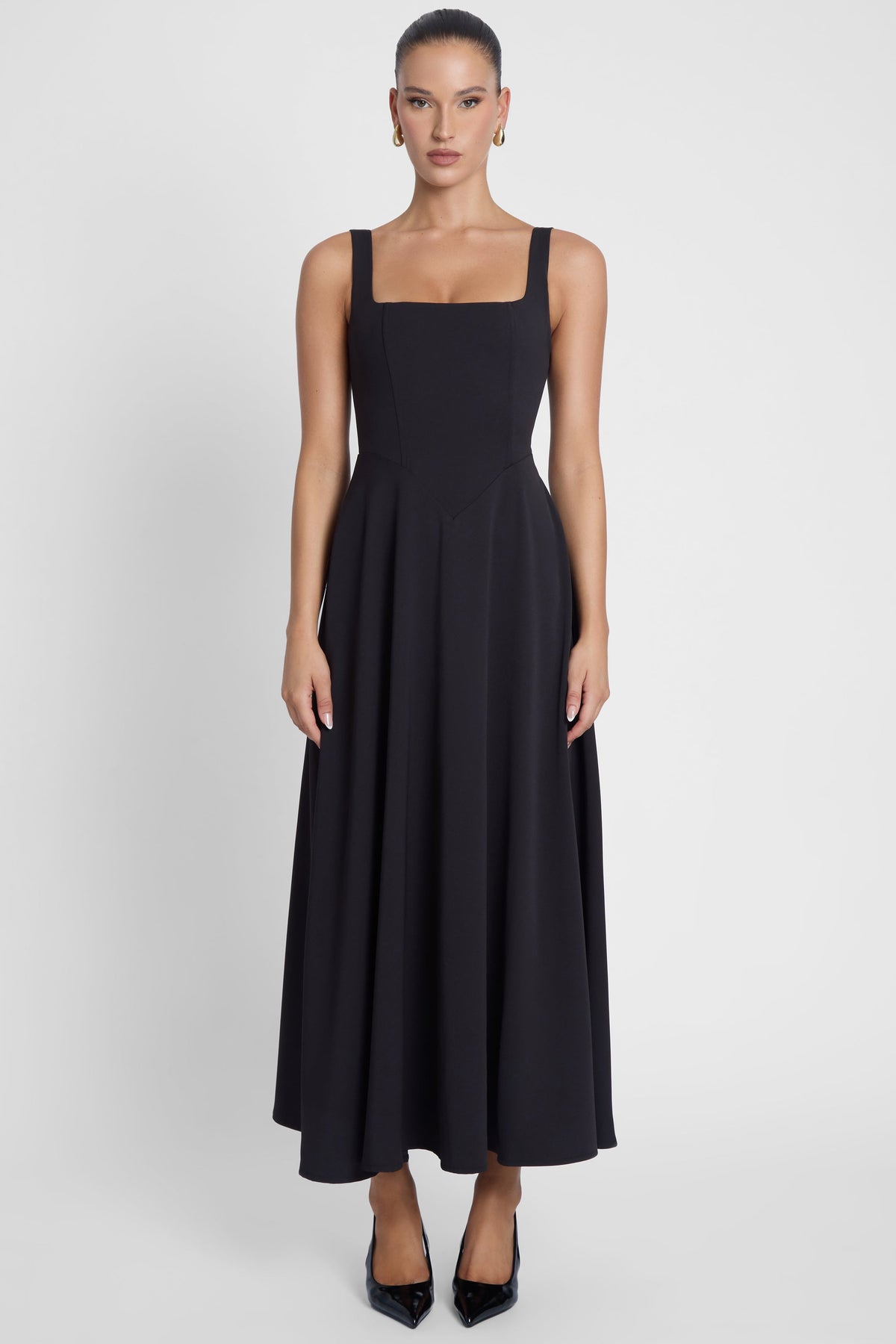 Model is wearing Serenity Square Neck Corset Midi Dress Black, front view.