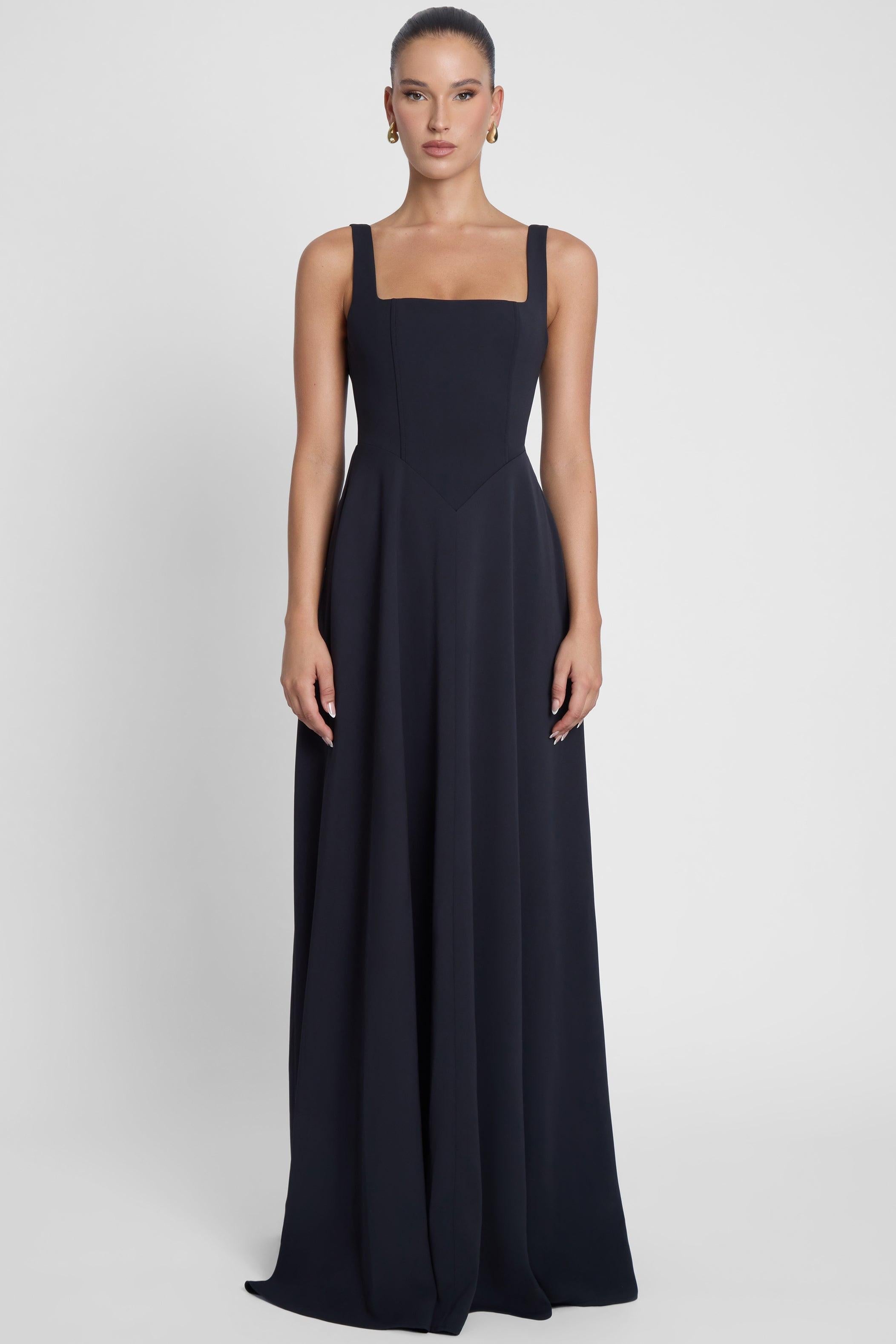 Model is wearing Siren Square Neck Corset Maxi Dress Black, front view.