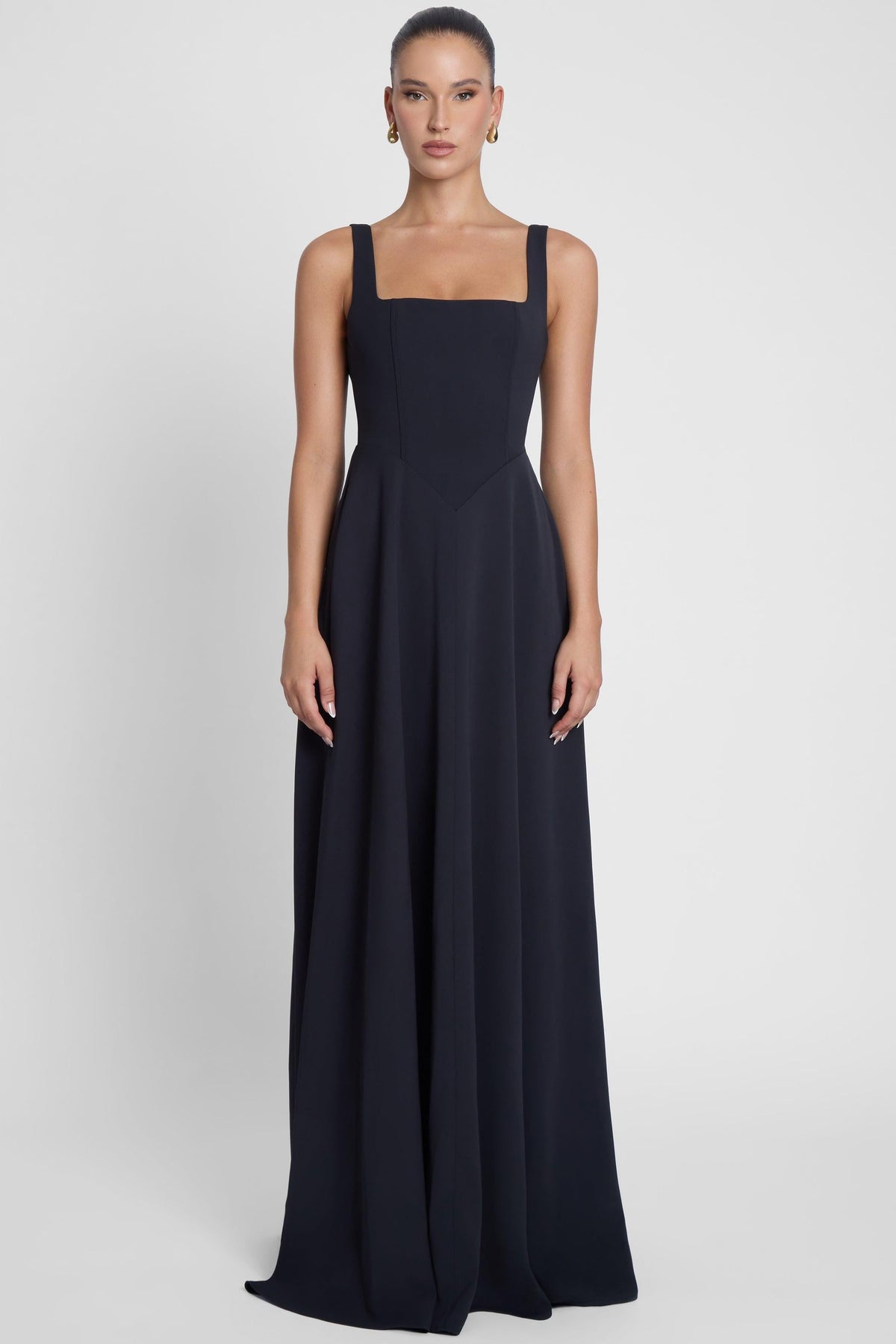 Model is wearing Siren Square Neck Corset Maxi Dress Black, front view.