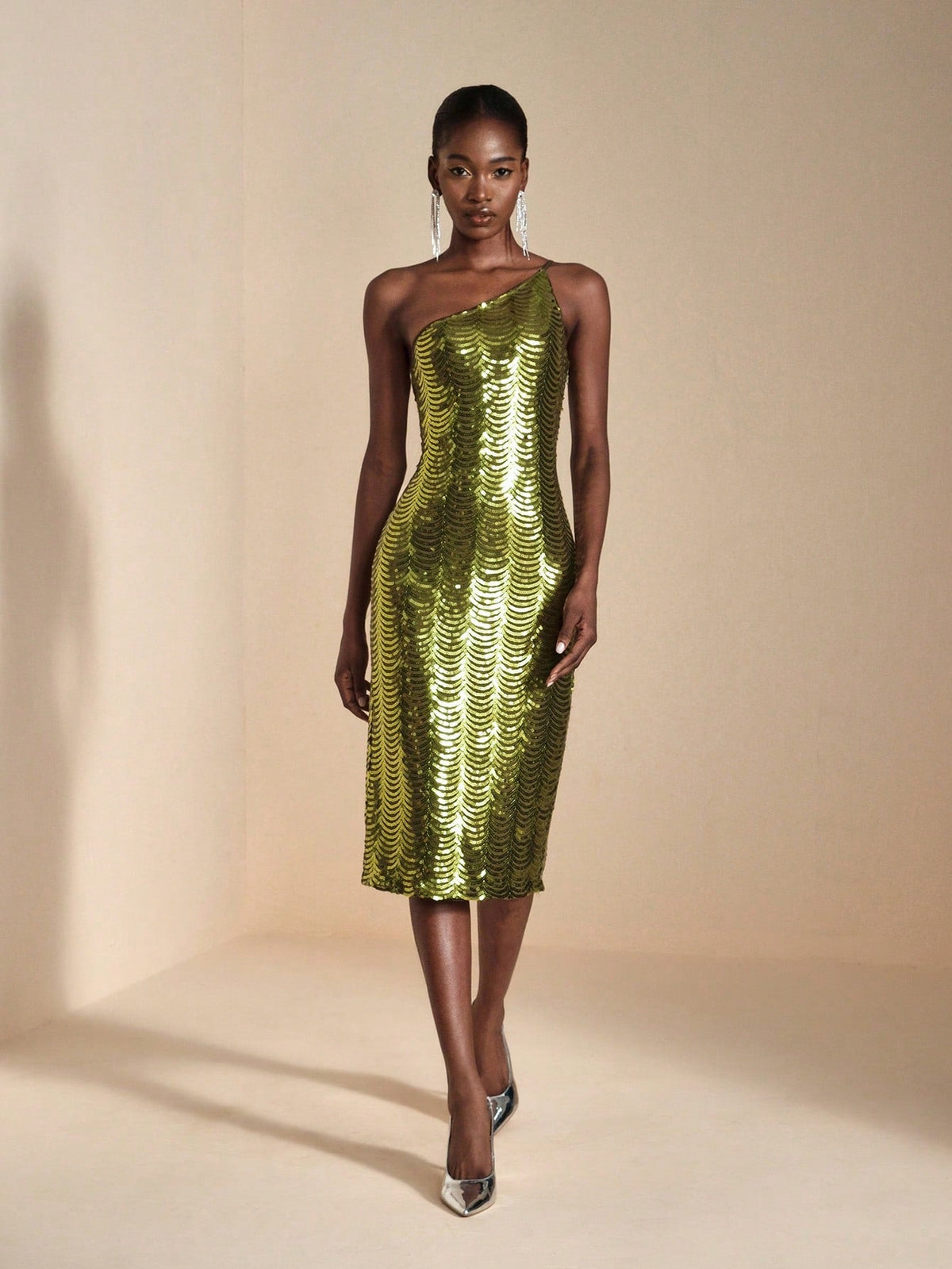 Turn heads at your next event in this show-stopping asymmetric sequin bodycon midi dress! Crafted with shimmering sequins that catch the light from every angle, this dress features a flattering bodycon silhouette and a cheeky side slit for movement and sass. The asymmetric neckline adds modern edge to classic elegance, making it perfect for cocktail parties, date nights, or anywhere you want to feel absolutely fabulous. Slip it on and let your confidence do the talking!