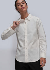 S=Person wearing a white dress shirt with a gray background