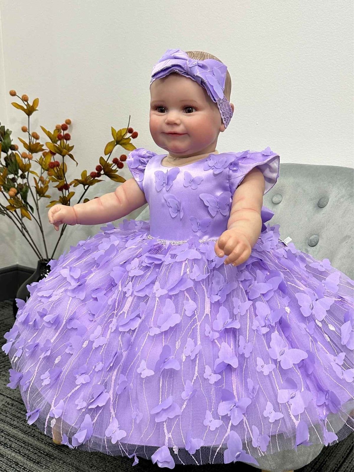 Baby in a purple dress with a matching headband for a special occasion.