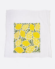 A tea towel with a lemon pattern. Shown lying flat.