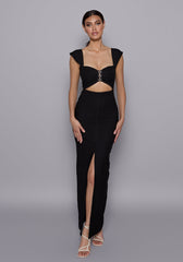 Model wearing the VSPR Morgan Black Maxi Dress with ruched bust, sweetheart neckline, and cap sleeves, standing against a neutral grey studio backdrop.