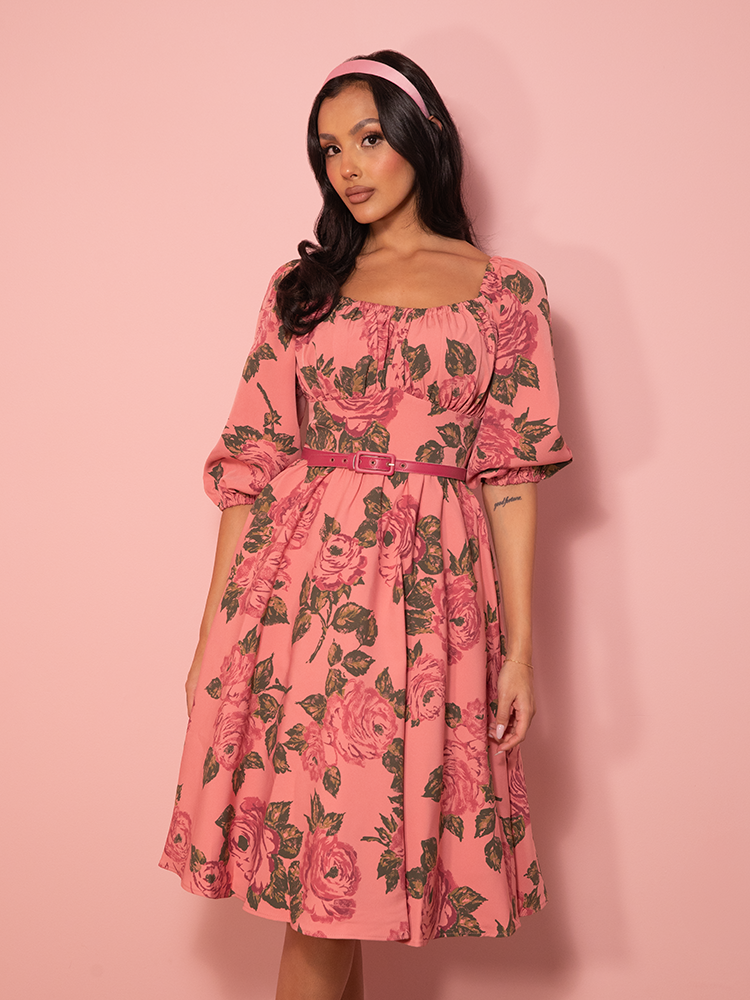 Soft, romantic, and vintage-inspired, this vacation dress blooms with delicate blush pink roses, featuring a flattering fit-and-flare silhouette.