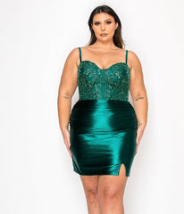 A woman models the Plus-Size Short Semi-Formal Dress Poly USA W1178 in green, featuring a beaded sweetheart bodice, spaghetti straps, fitted silhouette, and small front slit against a white background.