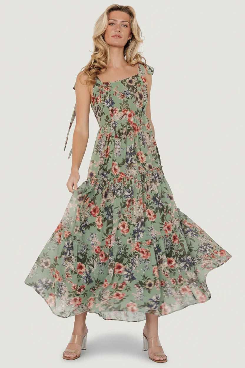 Front view of Anita Maxi Dress in green multi floral, chiffon overlay, square neckline, smocked back, and three ruffled tiers for flowy movement.