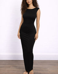Woman wearing a black sleeveless Knit Maxi Dress against a white wall.