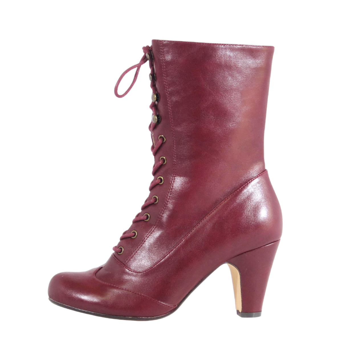 Claire is a burgundy high-heeled boot with laces, eyelets, and a side zip. Made from glossy PU leather, it features a rounded toe and medium, slightly flared heel for a chic look.