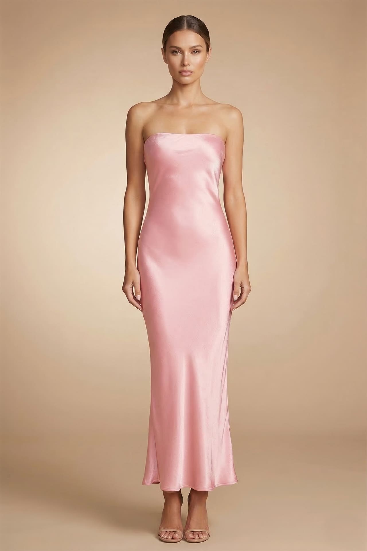 Front view of blush pink satin strapless midi dress with soft silhouette