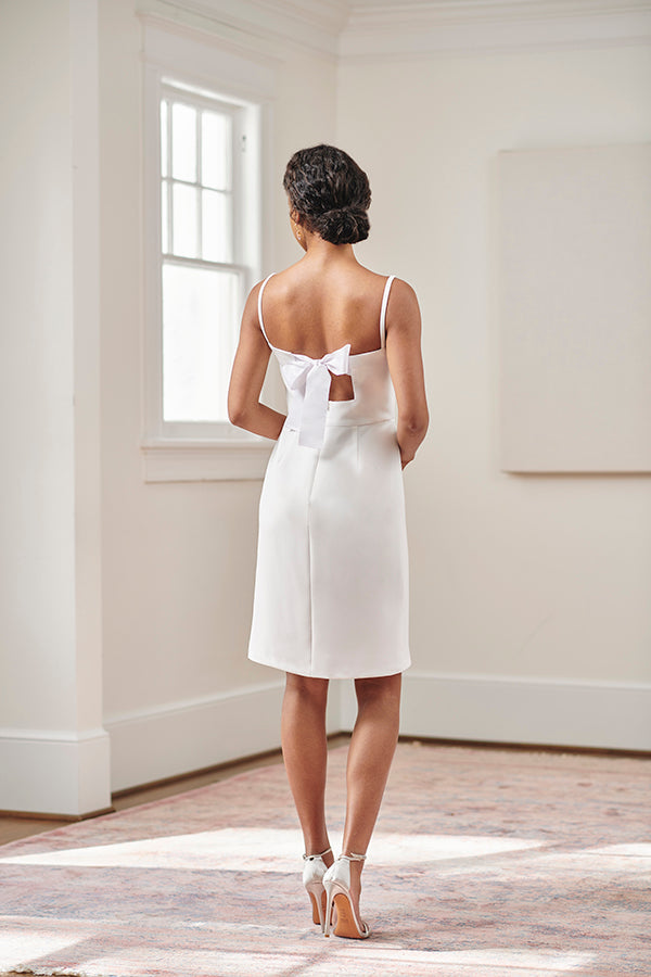 bride wearing short white backless ribbon tie bridal shower rehearsal dinner and civil wedding dress