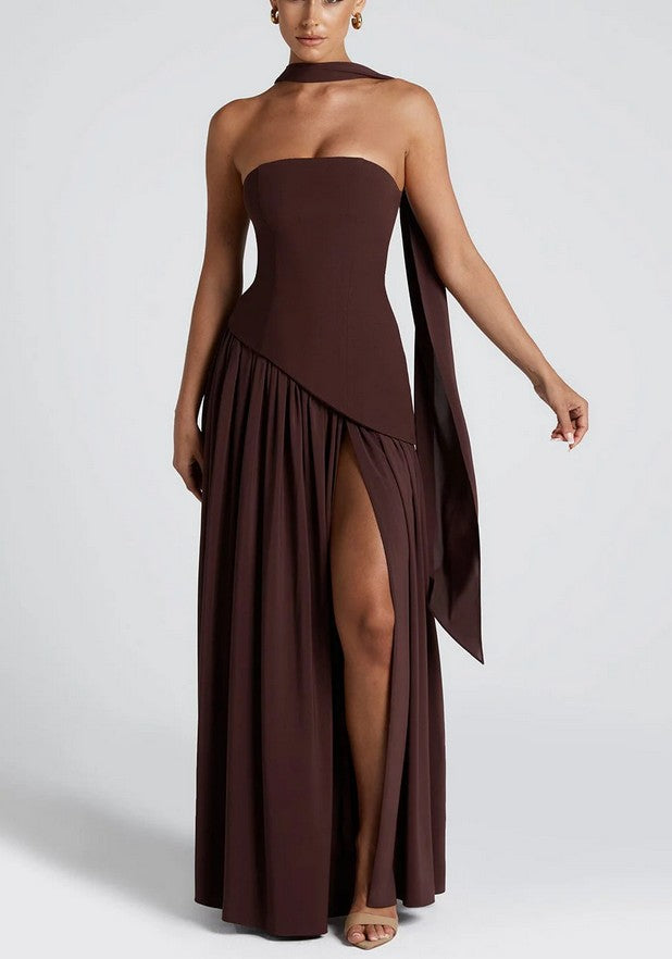 Model wearing espresso brown strapless maxi dress with crepe bodice, white chiffon skirt, thigh-high slit, and matching chiffon scarf.