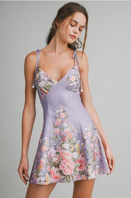 Floral fit-and-flare tie-shoulder mini dress by RARA Boutique, featuring a vibrant floral pattern and feminine silhouette.
