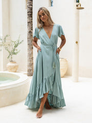 Woman wearing a light blue dress in a bathroom setting
