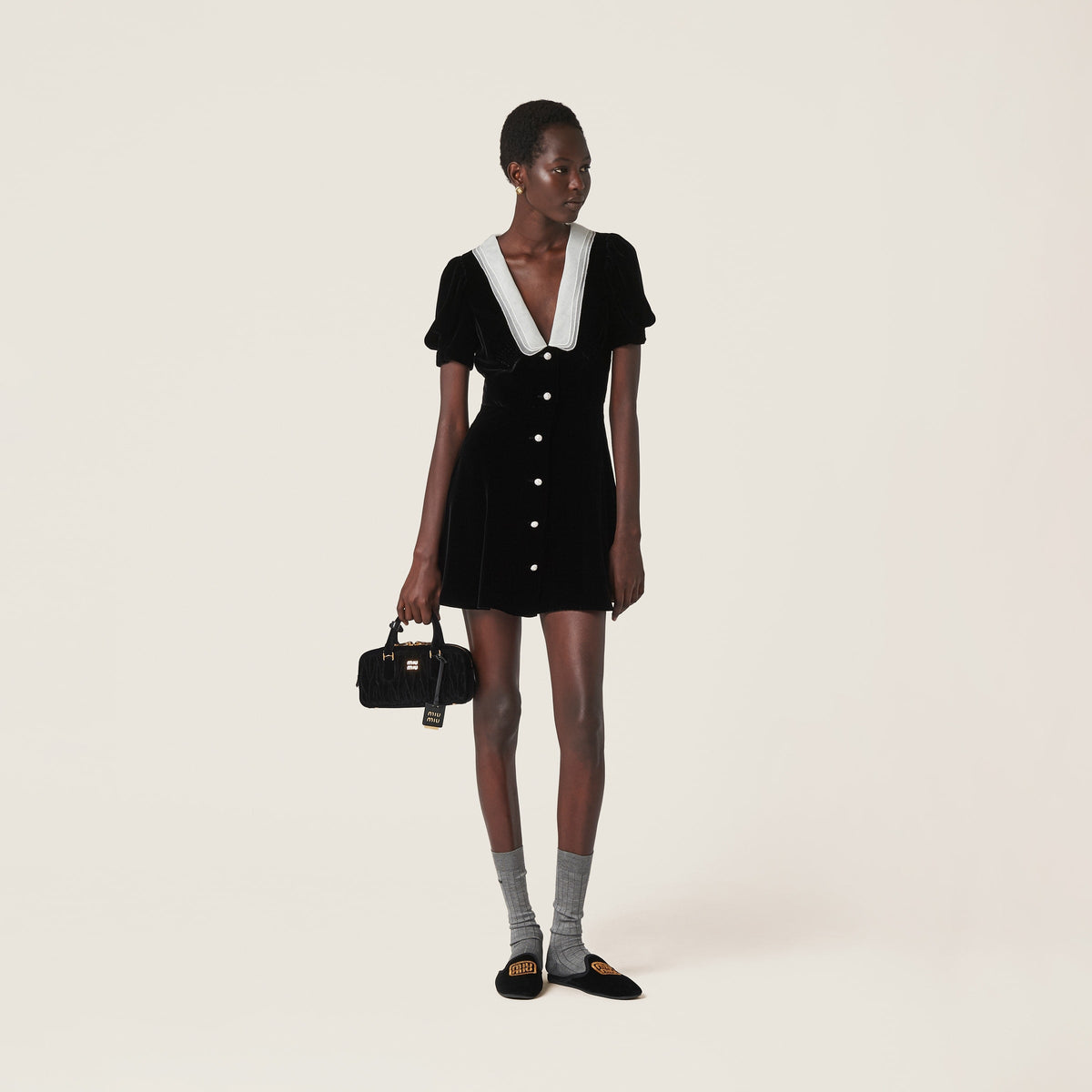 Introducing the luxurious MIU MIU V-neck organza-trimmed velvet minidress. Featuring new crystal button accents, silk lace splicing and elegant bubble sleeves, this dress exudes sophistication and style. Elevate your wardrobe with this must-have dress.