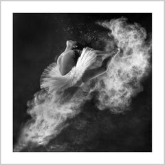 A dancer in a white tutu leaps gracefully, surrounded by swirling white powder against a dark background. – Arteve Gallery