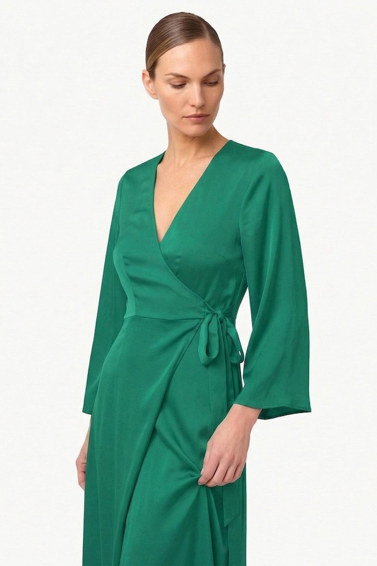 Emerald green satin wrap maxi dress with long sleeves and elegant drape