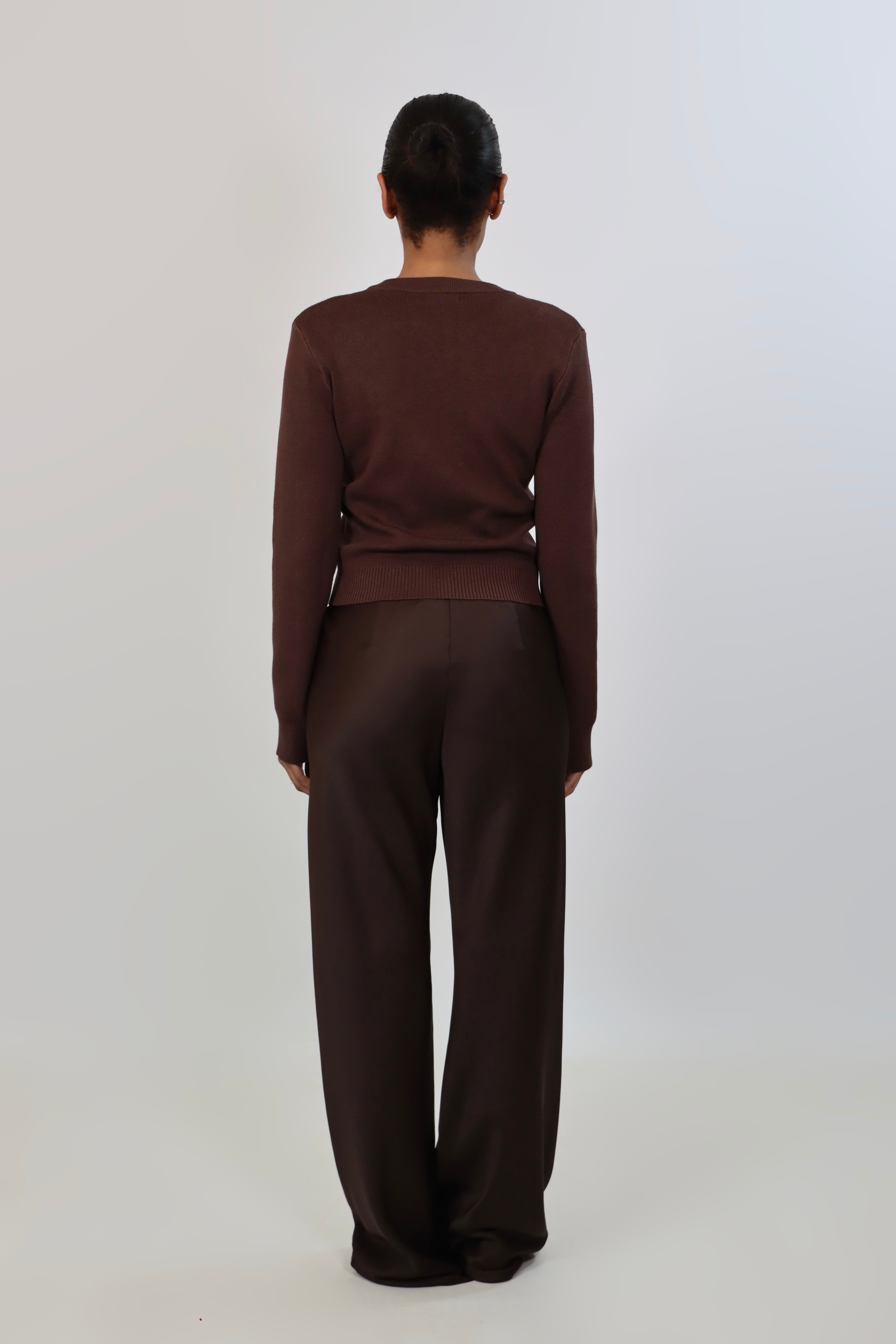 Elegant mid-waist wide-leg satin pants in a rich espresso brown shade, featuring a smooth, glossy finish and a fluid drape for a sophisticated, effortless look.