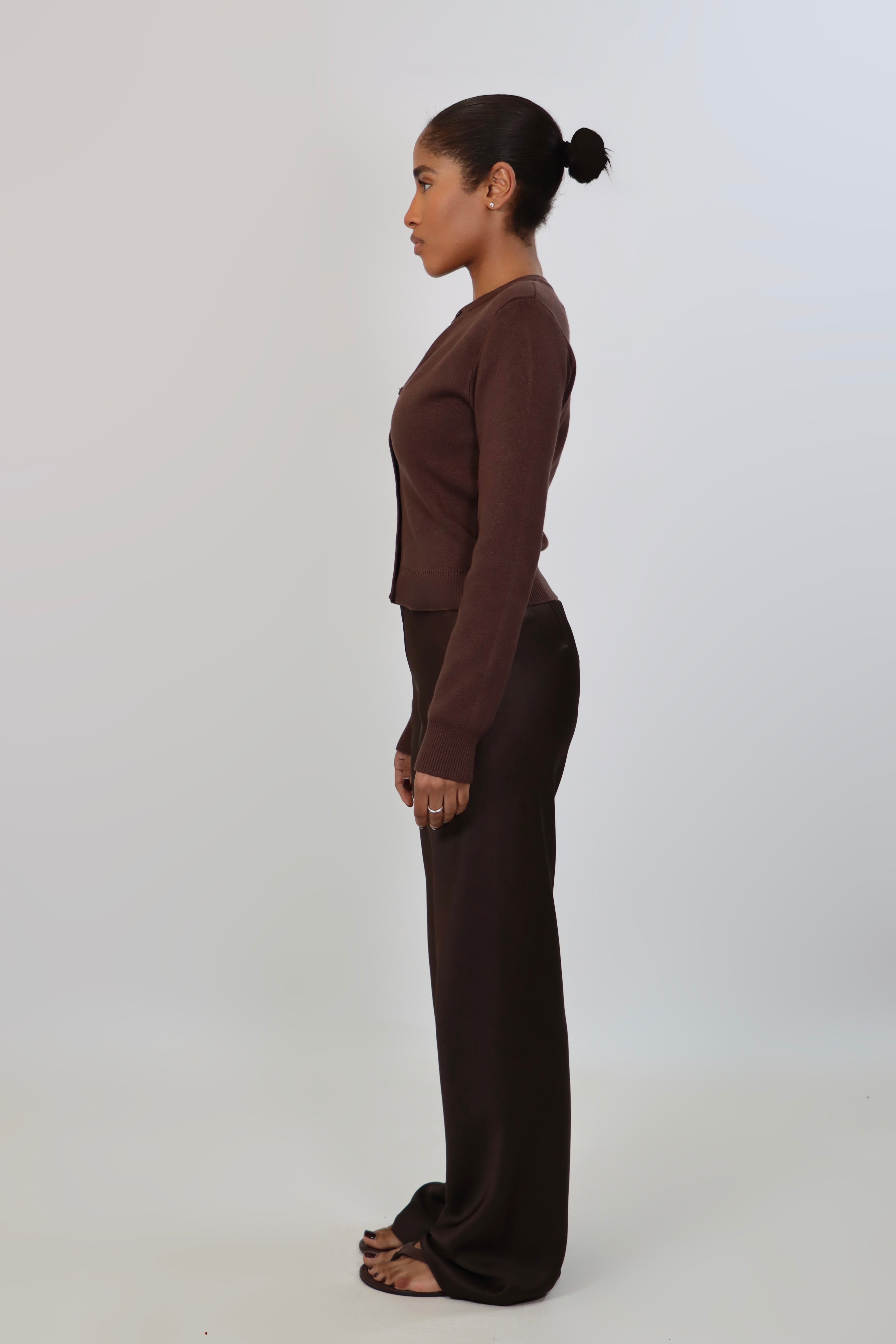Elegant mid-waist wide-leg satin pants in a rich espresso brown shade, featuring a smooth, glossy finish and a fluid drape for a sophisticated, effortless look.