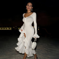 Long sleeve button-down dress with ruffled hem and slit, ideal for an evening event, accessorized