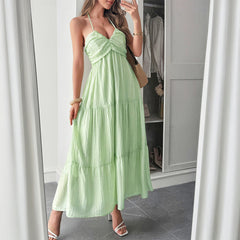Woman wearing a flowy halterneck tiered maxi dress with ruffle details styled for a boho summer vacation look, vacation outfits, Summer beach maxi dress, summer fits, backless maxi dress, summer dresses, boho maxi, vacation dresses.