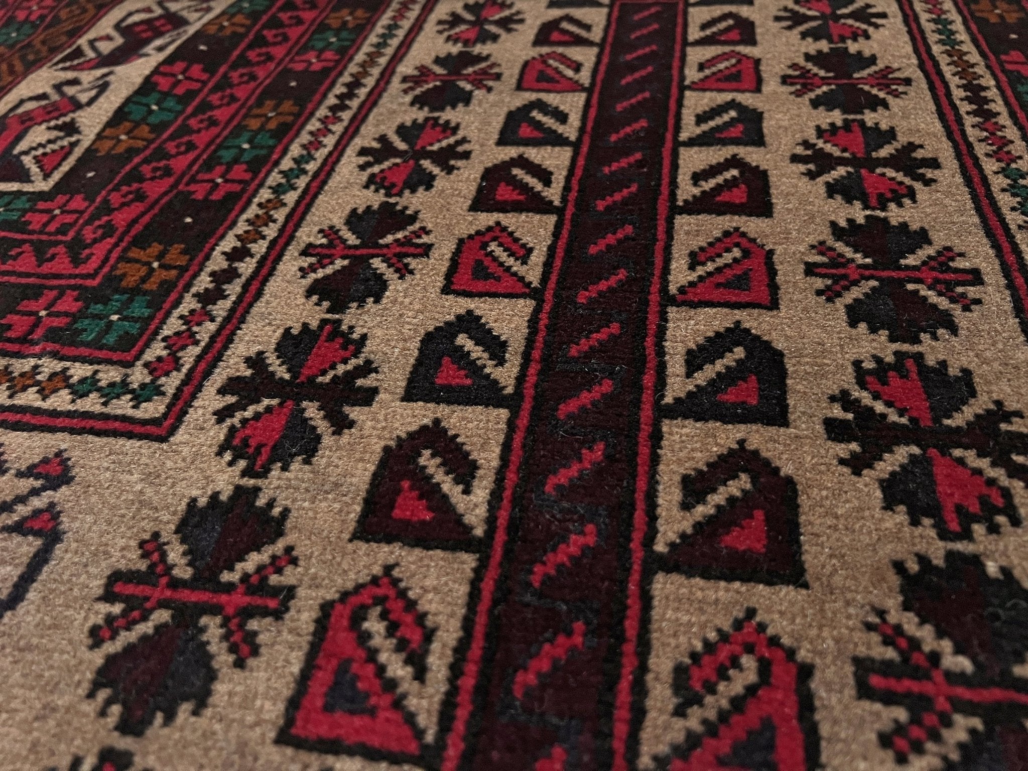 Detail of a Baluch Turkmen Prayer Rug - Handmade Wool Carpet in a 3x5 size, featuring traditional tribal geometric patterns with rich red, black, beige, green, and teal colors. Ideal for living room, bedroom, kitchen, entryway, or nursery decor. Available at a handmade rug shop in the San Francisco Bay Area.