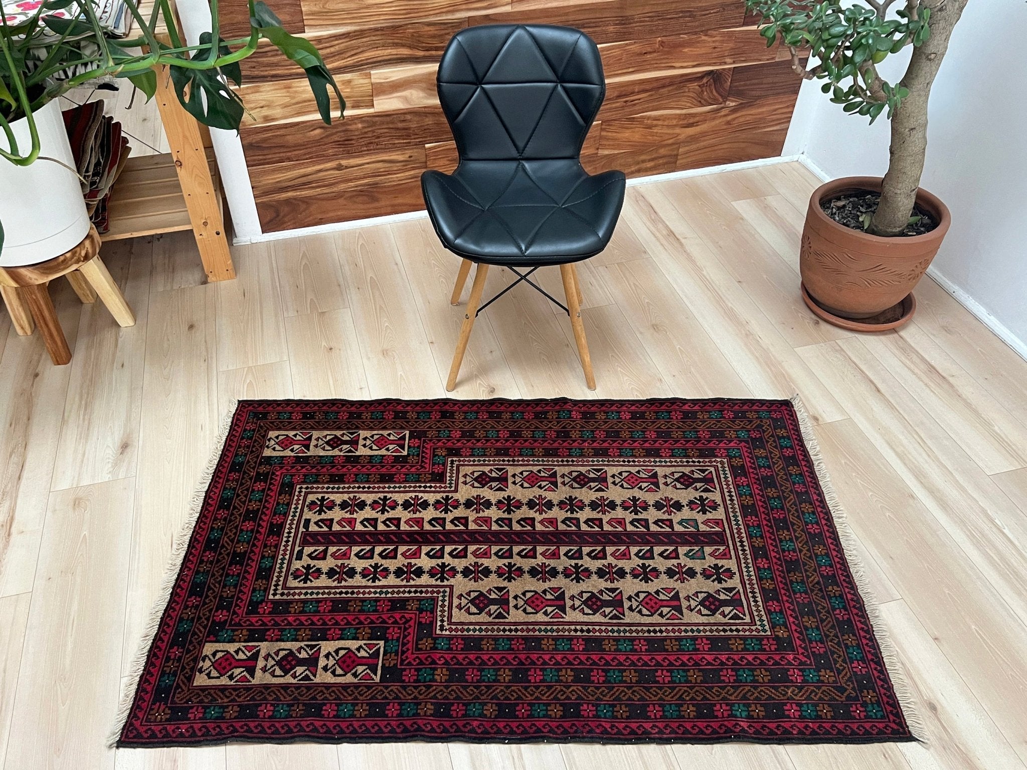 Living room picture of a Baluch Turkmen Prayer Rug - Handmade Wool Carpet in a 3x5 size, featuring traditional tribal geometric patterns with rich red, black, beige, green, and teal colors. Ideal for living room, bedroom, kitchen, entryway, or nursery decor. Available at a handmade rug shop in the San Francisco Bay Area.