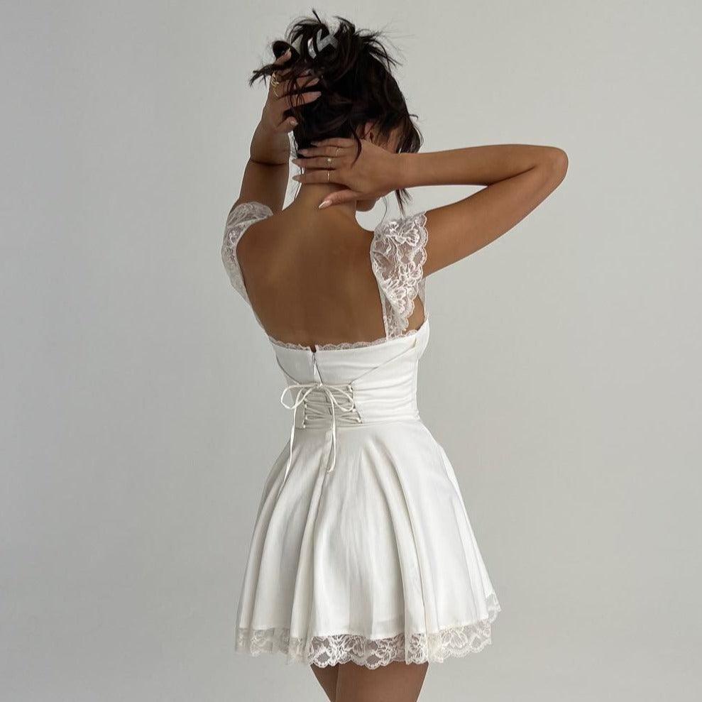 White lace-trimmed mini dress with open back.