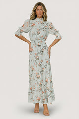 Front view of Marie Mock Neck Maxi Dress in sage floral print, chiffon fabric, high smocked neckline, keyhole back and single-tier maxi skirt.