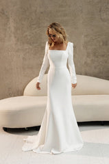 minimalist  elegant white wedding dress with long sleeves, featuring a square neckline and buttons on the back.