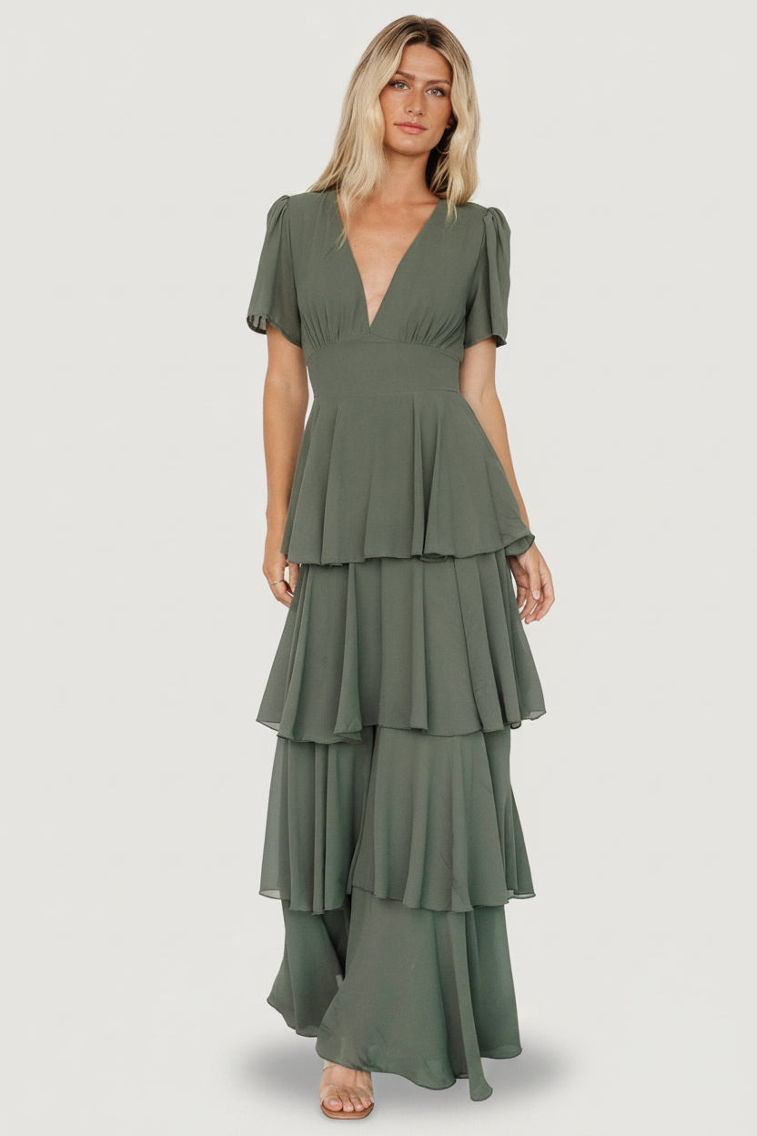 Model posed in Dark Sage Montaigne Ruffle Maxi Dress showing side profile of cascading ruffles, contoured underbust and smocked back with gentle, flowing chiffon drape.