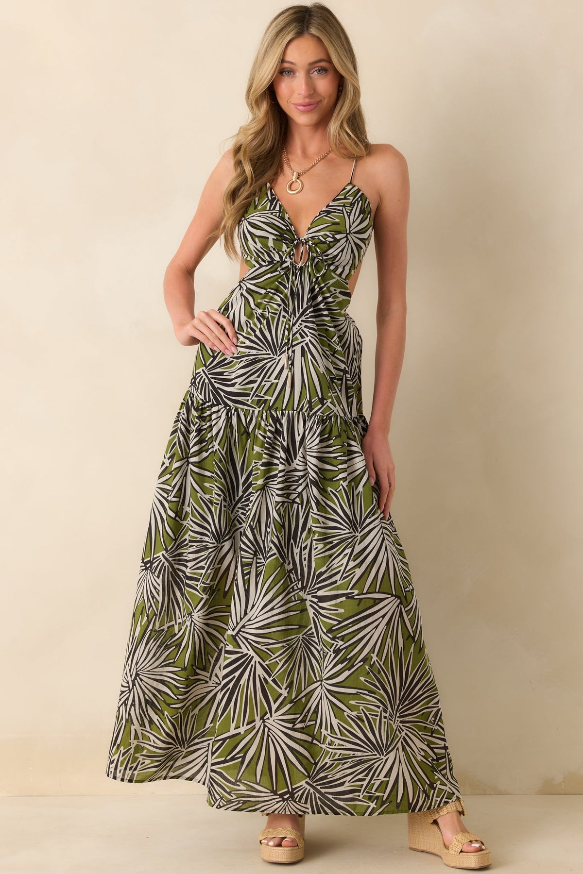 Full body front view of the olive green maxi dress showcasing the black and white palm frond print and v-neckline.