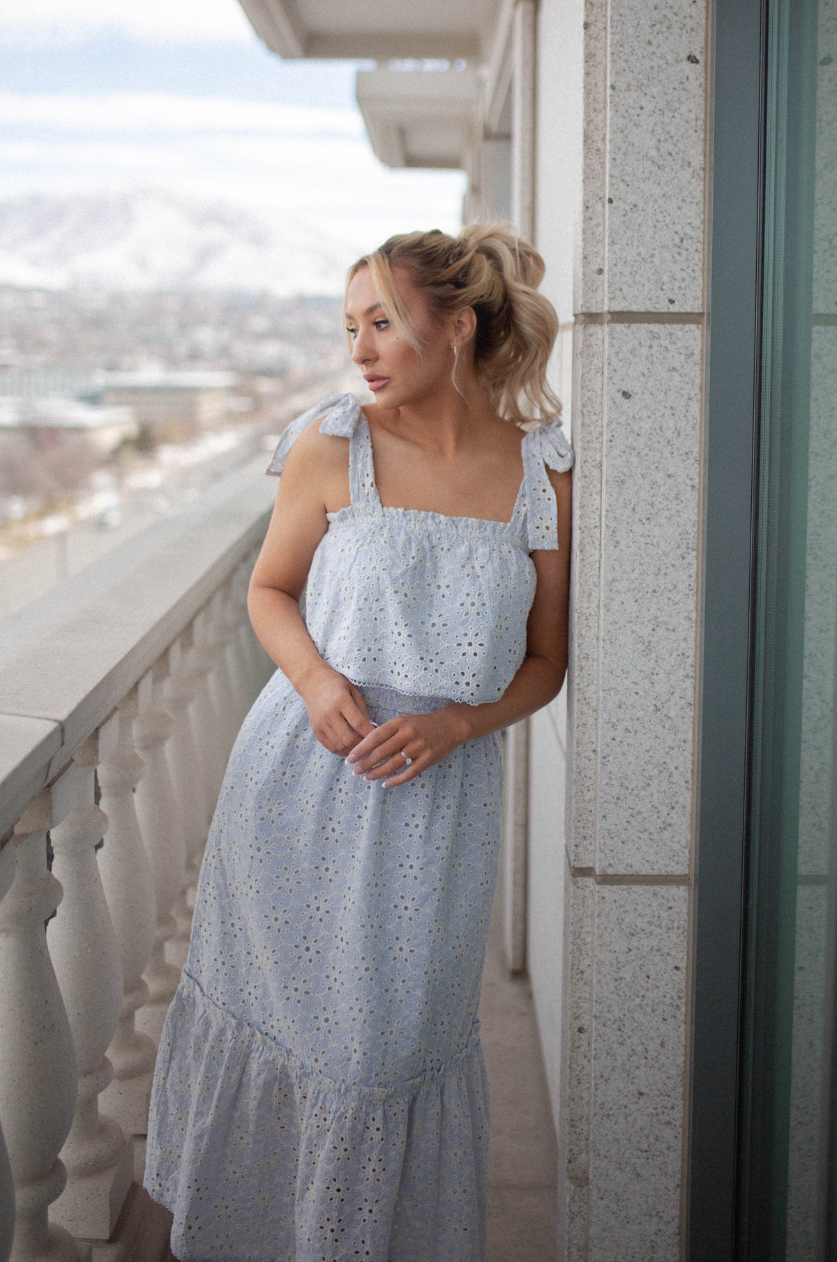 blue eyelet summer midi dress with ruffle detailing and tied shoulder straps