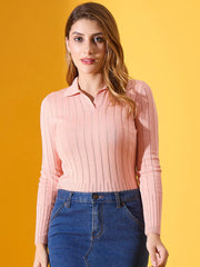 Woman wears a 98degreenorth salmon ribbed collar neck sweater and blue denim skirt against a yellow background.